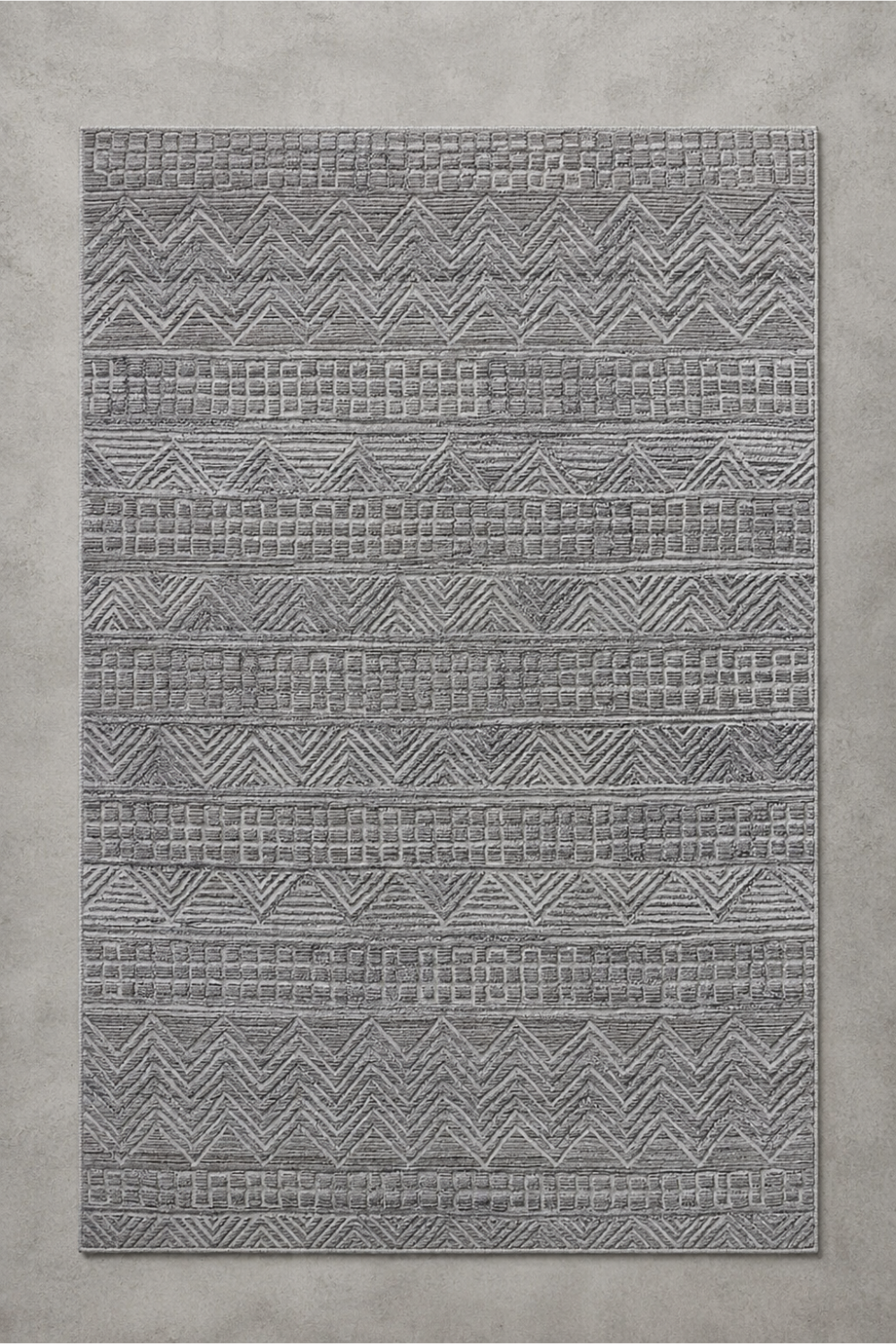 Urban Ridge handcrafted handloom over hand tufted ash grey New Zealand wool area rug featuring carved chevron and geometric stripe patterns