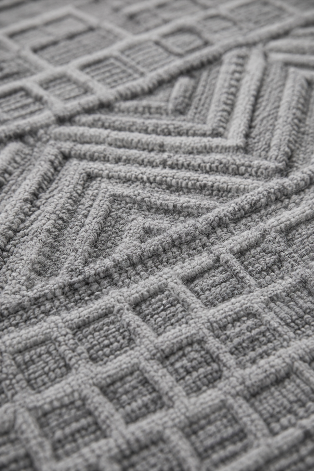 Close-up of the Urban Ridge handloom over hand tufted New Zealand wool rug showcasing raised chevron patterns and handcrafted geometric wool texture