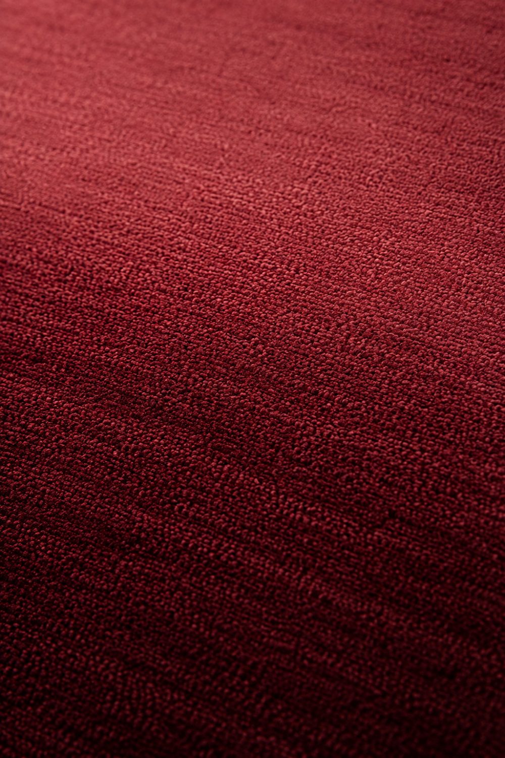 Close-up of the Velour Rouge handloom New Zealand wool rug showcasing its burgundy ombre texture and handcrafted weave.