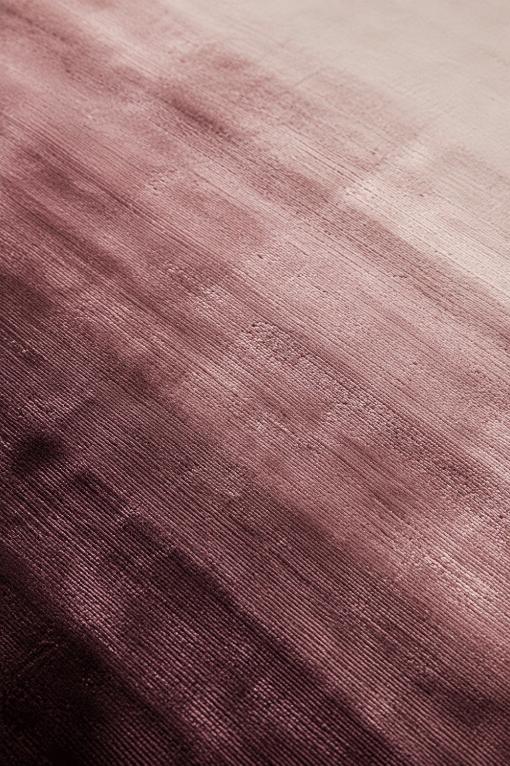 Close-up of the Velvet Horizon handloom Tencel rug showcasing its layered plum gradient, silky texture and handcrafted finish