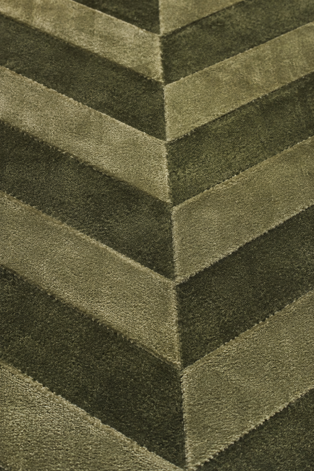 Close-up of the Verdant Chevron Rug highlighting the carved chevron texture and premium Handloom Viscose Tencel Bamboo craftsmanship.